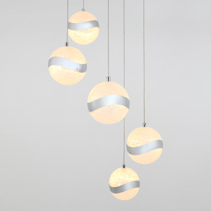 The Artika Wavey 5-light LED pendant features five frosted spherical lights with metallic silver diagonal bands, suspended at different heights against a plain light gray background.