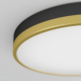 Close-up of a modern round ceiling light with a black and gold rim, mounted on a white ceiling. The design is sleek and minimalistic, with the light emitting a soft, even glow.