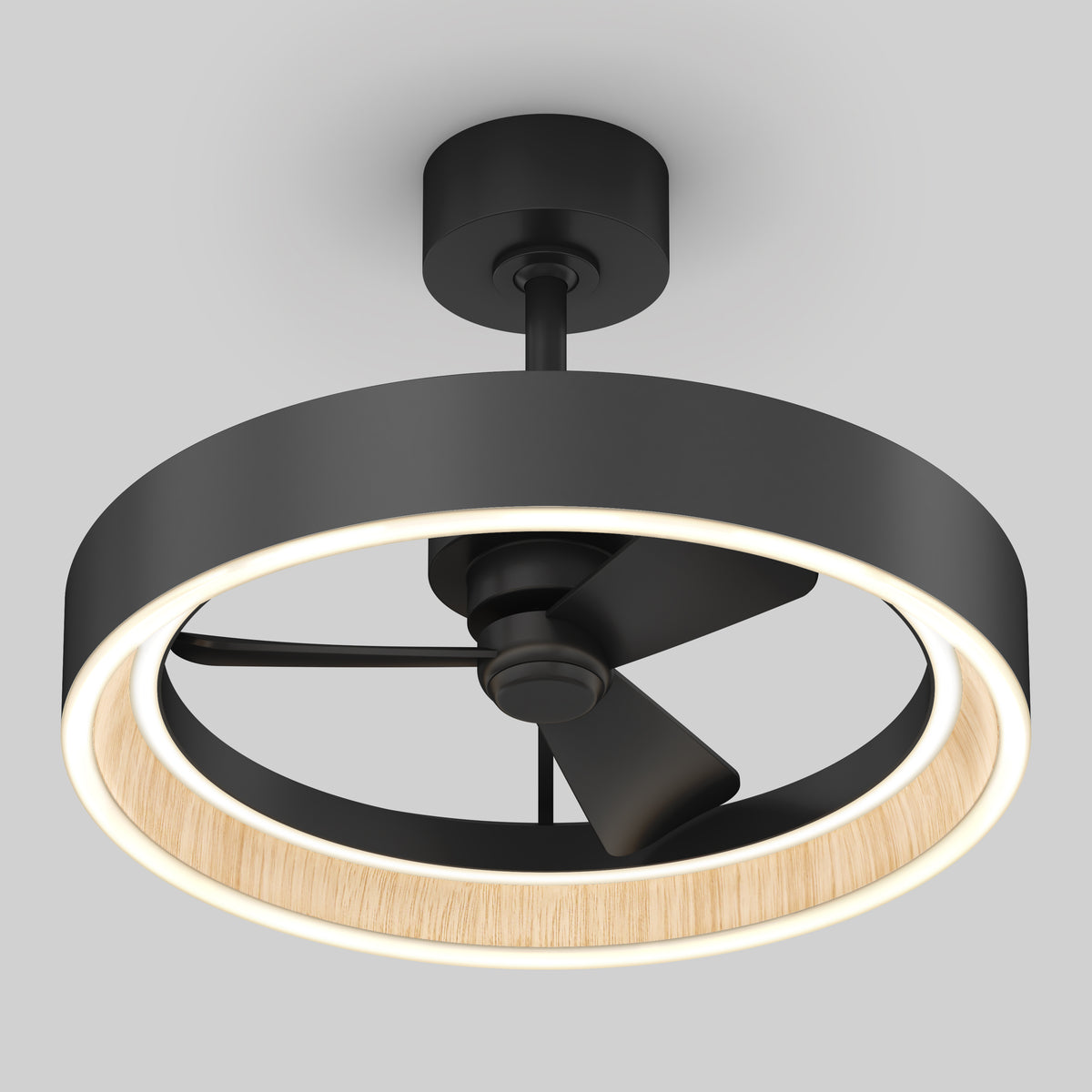 A modern ceiling fan with three black blades, surrounded by a circular LED light ring with a wood accent on the inner edge, mounted on a black base against a light gray background.
