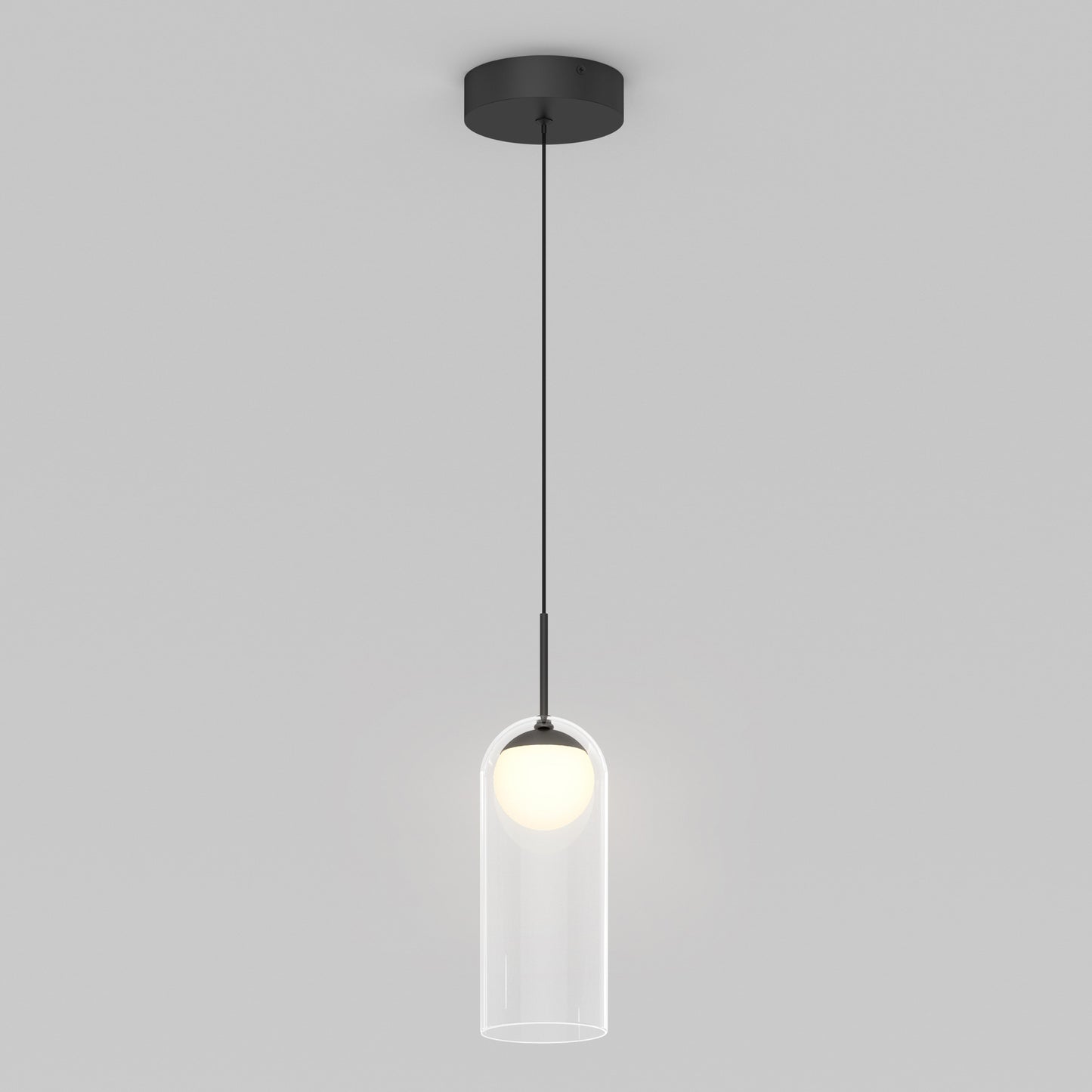 The Artika Mirah LED modern mid-century pendant light 3 CCT features a black ceiling mount and cord, with a round white bulb in a clear cylindrical glass shade, displayed against a plain light gray background.