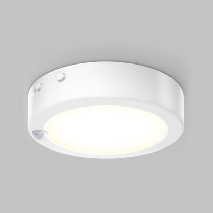 Artika Accent under cabinet LED light 3CCT with a glowing center and small sensor on the edge, mounted on a plain gray ceiling.