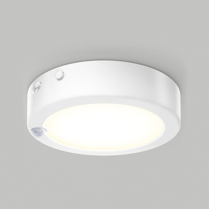 Artika Accent under cabinet LED light 3CCT with a glowing center and small sensor on the edge, mounted on a plain gray ceiling.