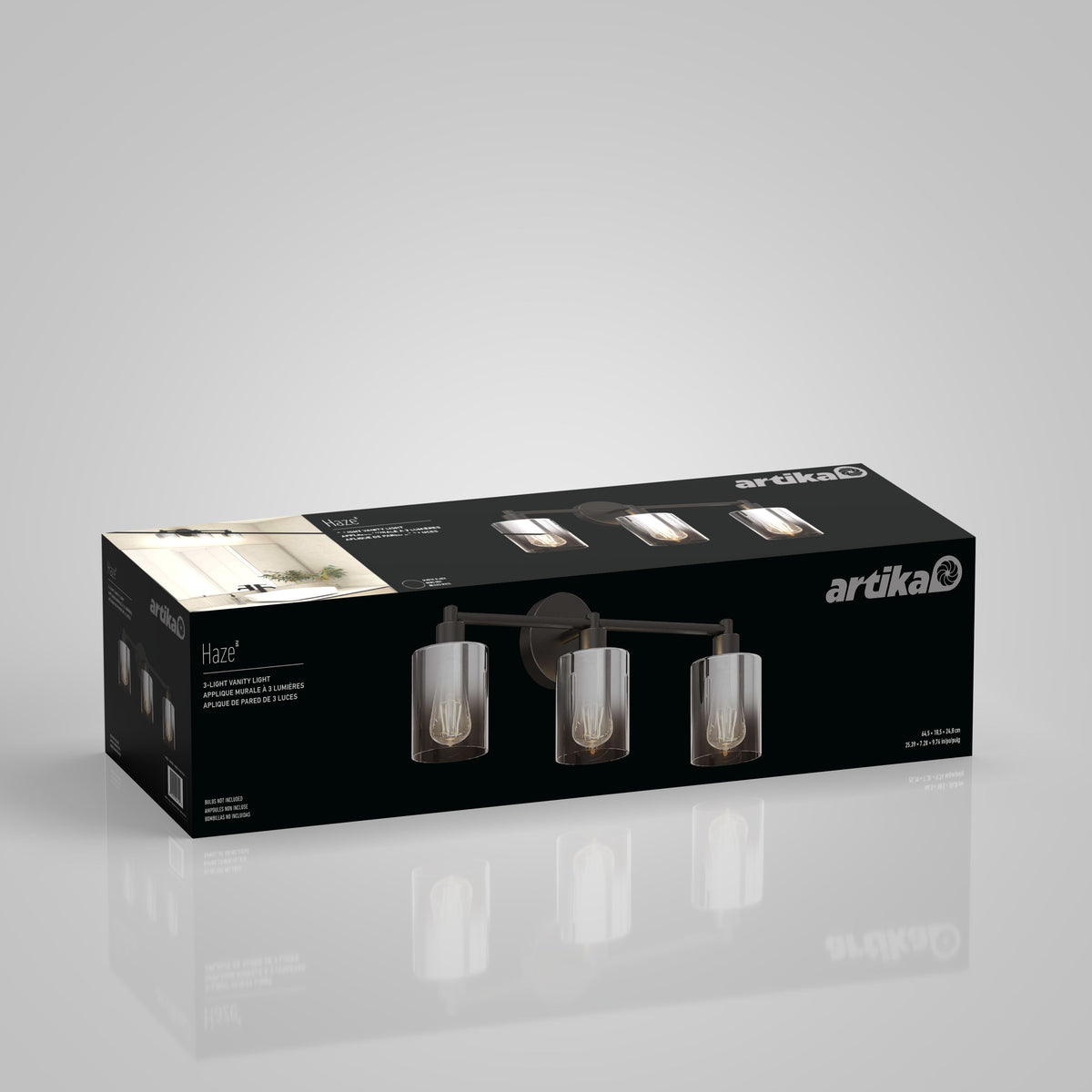 A rectangular black Artika box displays a three-light wall vanity fixture called Haze, with images of the modern light fixture featuring clear cylindrical glass shades and exposed bulbs on the packaging.