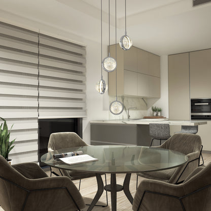 Modern kitchen and dining area featuring a round glass table, four cushioned chairs, beige cabinetry, marble backsplash, built-in oven, potted plant, striped window blinds, and the Artika Avalon 4-light LED pendant.