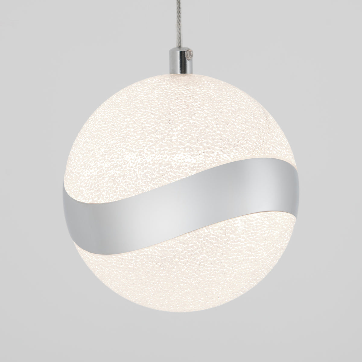 A spherical pendant light with a textured white surface and a wavy metallic silver band wrapping around its middle, suspended from a cable against a plain light gray background.