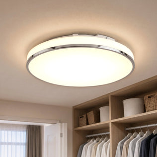 The Artika Summit 15 in. LED Flush Mount 5CCT brightens a walk-in closet with shelves, baskets, and hanging clothes below.