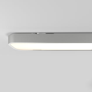 A close-up of the Artika Europa 36 LED flush mount light, featuring a modern rectangular design with smooth rounded edges, mounted on a white ceiling and emitting a soft, even glow. Comes with remote control.
