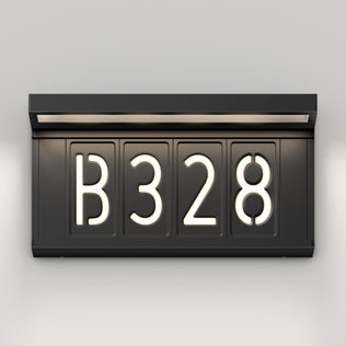The Artika Bowen solar LED outdoor address wall light 5 CCT displays "B 3 2 8" in bright white, modern, rounded font on a black illuminated sign, mounted on a light-colored wall with a built-in top light.