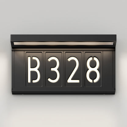 The Artika Bowen solar LED outdoor address wall light 5 CCT displays "B 3 2 8" in bright white, modern, rounded font on a black illuminated sign, mounted on a light-colored wall with a built-in top light.
