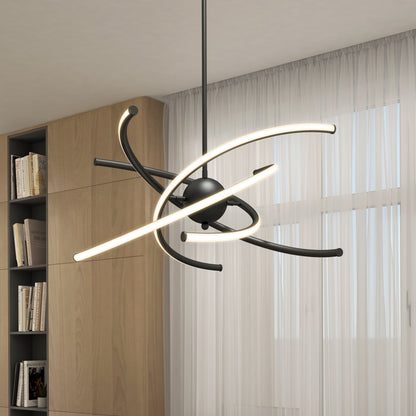 The Artika Silvio LED pendant light 3 CCT features curved, glowing LED bars around a central black sphere, hanging in a room with sheer white curtains and a built-in wooden bookshelf.