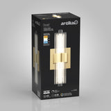 A black rectangular box displays the Artika Dorado LED wall sconce with a modern gold and glass design. Product features and specifications are shown in white and blue on the packaging.