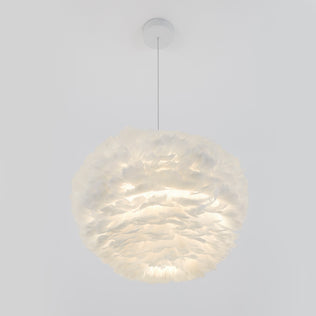 The Artika Plume LED pendant light, featuring a round, feather-like white design and textured layers, hangs from a thin cord and emits a soft, diffused glow against a plain white background.