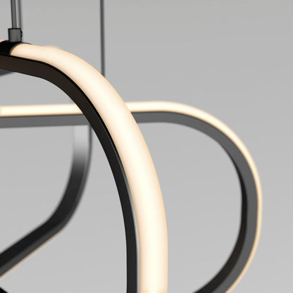 Close-up of the Artika Lewis modern LED pendant light 3 CCT, featuring smooth curved black metal arms and soft white integrated LED lighting, set against a plain light gray background.