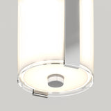 A close-up view of a modern ceiling light fixture with a cylindrical frosted glass shade and a metallic accent, emitting a soft, even glow.