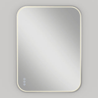 The Artika Royce Dimmable LED Mirror features edge-lit LED lighting, three touch controls including colour temperature adjustment, and can be mounted horizontally or vertically against a plain light gray wall.