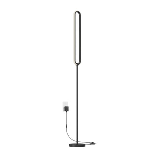 The Artika Leni dimmable LED modern floor lamp features a black finish, oval-shaped LED top, and round base. A black cord and adapter plug it into a white wall outlet.