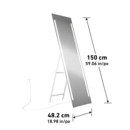 The Artika Emeraude Full Length Mirror is a tall, rectangular mirror with built-in LED lights on a white foldable frame, measuring 150 cm (59.06 in) high and 48.2 cm (18.98 in) wide, powered by a white cord plugged into an outlet.