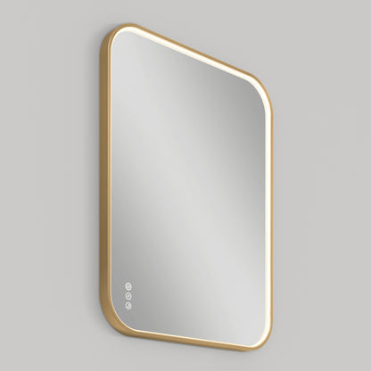 The Artika Royce Dimmable LED Mirror, 3 CCT, with a gold frame and rounded corners, displays three circular touch controls in the lower left and is mounted horizontally on a light gray wall.