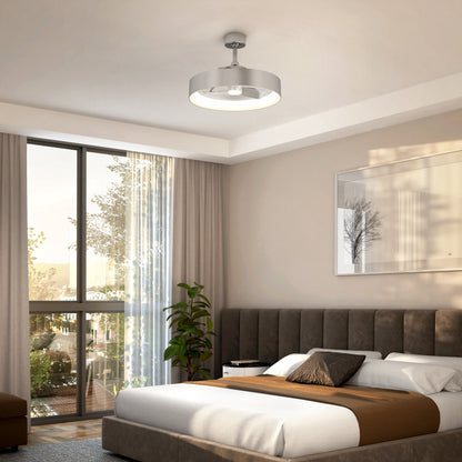 A modern bedroom with a large window, beige walls, a gray tufted bed, white and brown bedding, a potted plant, a framed tree artwork, and a round silver ceiling light fixture. Sunlight streams into the room.