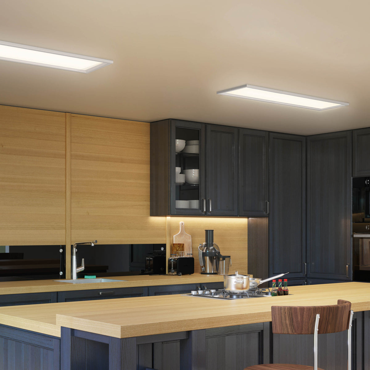 Modern kitchen with dark cabinets, light wood countertops, built-in stove, and overhead rectangular ceiling lights. Shelves display white dishes, and a chair is placed at the kitchen island.