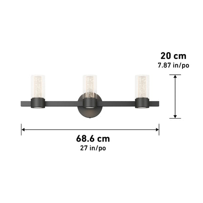 The Artika Novello modern LED bathroom vanity light features three cylindrical glass shades on a horizontal black bar, measuring 68.6 cm (27 in) wide by 20 cm (7.87 in) tall.