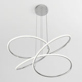 A modern ceiling light fixture with three intertwined, metallic and white LED rings suspended by thin cables from a round silver ceiling mount against a plain white background.
