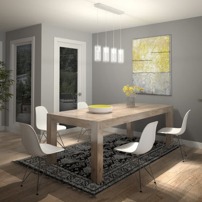 A modern dining room with a wooden table, four white chairs, a black patterned rug, a vase of yellow flowers, an abstract painting on the wall, and the Artika Hologram 4-light LED pendant hanging above the table.