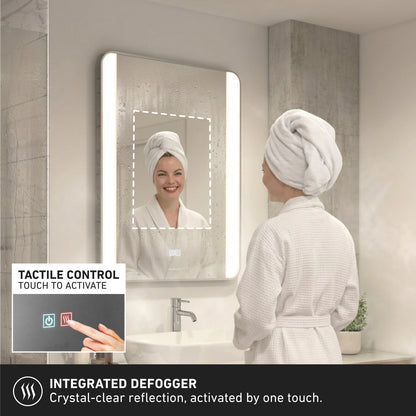 A woman in a white bathrobe smiles at her reflection in the Artika Onyx dimmable LED mirror 3 CCT. An inset shows a finger using the touch control to activate the illuminated, anti-fog feature for clear visibility.