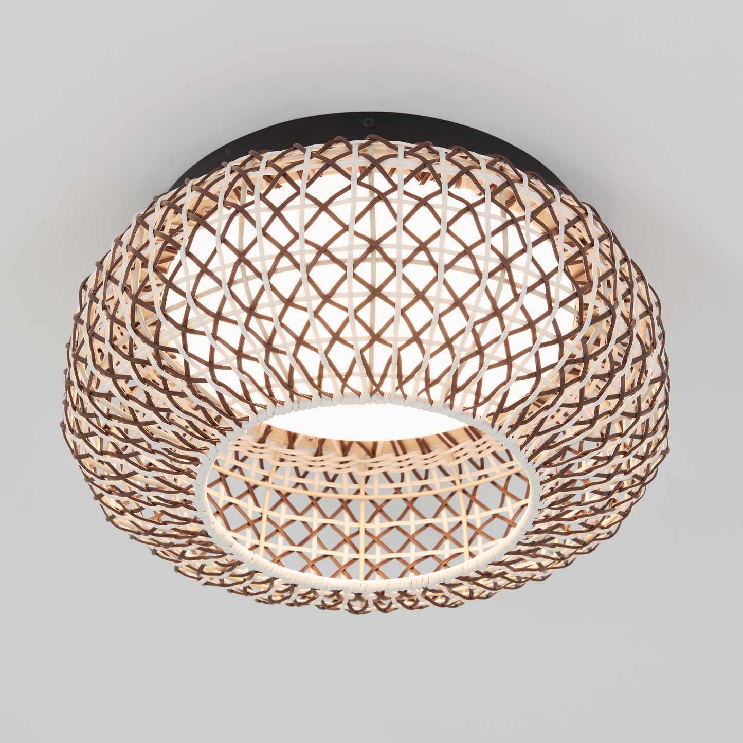 The Artika Benson 15 in. LED flush mount light features a woven lattice-style rattan shade, a bright white inner diffuser, and mounts flush to the ceiling with selectable 5 CCT settings.