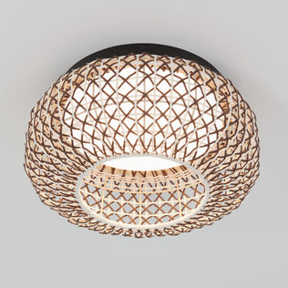 The Artika Benson 15 in. LED flush mount light features a woven lattice-style rattan shade that casts warm, decorative patterns around its central white light, making it a stylish and inviting ceiling fixture for any space.