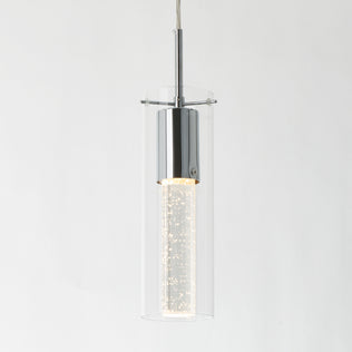 The Artika Bubble Flow 1-light pendant 2 features a modern cylindrical design with a chrome finish, clear glass outer shade, and a glowing bubble-filled inner tube, all suspended by a thin cord against a white background.