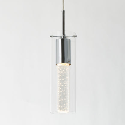 The Artika Bubble Flow 1-light pendant 2 features a modern cylindrical design with a chrome finish, clear glass outer shade, and a glowing bubble-filled inner tube, all suspended by a thin cord against a white background.