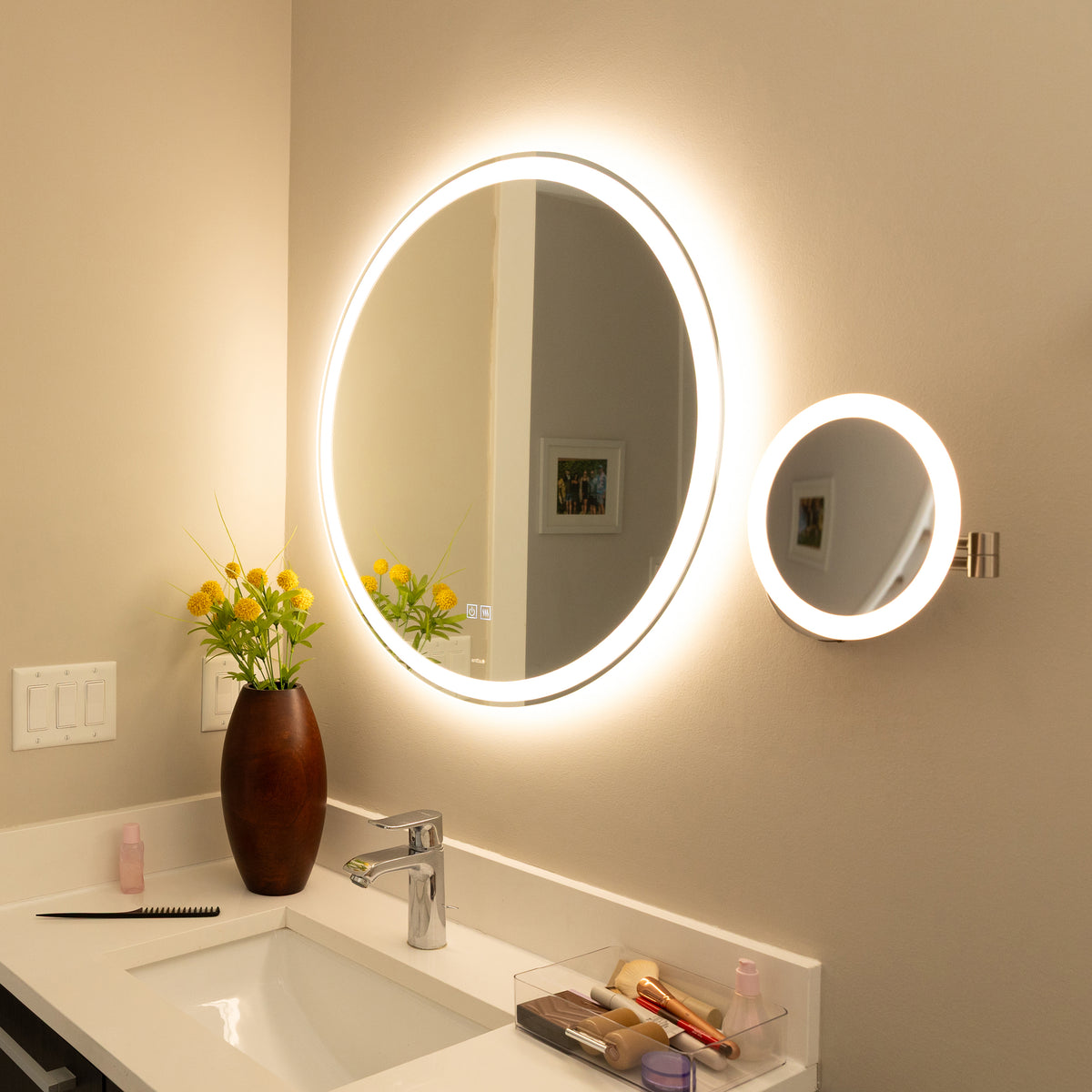 A bathroom vanity with the Artika Radia 9 in. Cordless LED Cosmetic Mirror and makeup items on the countertop.