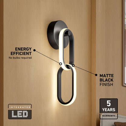 The Artika Catena modern LED wall sconce features a matte black finish, integrated energy-efficient LED with 5 selectable color temperatures, no bulbs required, and includes a 5-year warranty—shown here on a light wood wall.