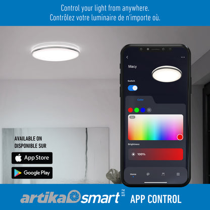 A Macy 15 in. LED modern flush mount light by Artika is controlled via a smart app on a smartphone in a stylish room. App Store and Google Play logos appear with “Control your light from anywhere” in English and French.