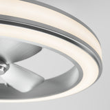 Close-up of a modern ceiling fan with metallic blades and a circular LED light ring, set against a plain light gray background.