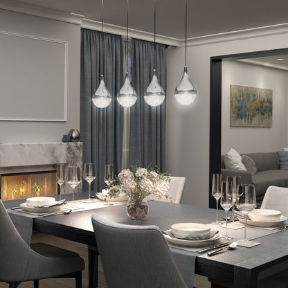 A modern dining room features a set table, four Artika Glitzer 4-light LED pendants overhead, gray chairs, a fireplace on the left, blue curtains, and a living room with a sofa and abstract wall art in the background.