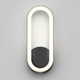 A modern, oval-shaped wall sconce with a black base and a continuous white LED light forming the outer edge, mounted on a light gray wall.