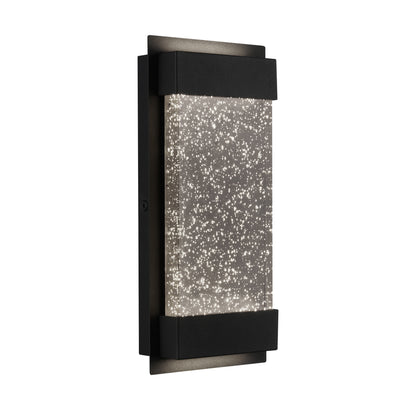 The Artika Essence Glow Box is a modern indoor-outdoor LED wall light featuring a black frame and central frosted glass embedded with sparkling bubbles, producing a starry effect when illuminated.