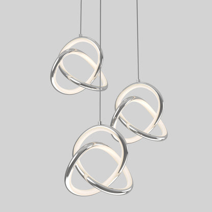 The Artika Zephyr 3-light LED pendant features intertwined chrome and glowing white loops hanging at varying heights against a light gray background, exemplifying sleek modern lighting.