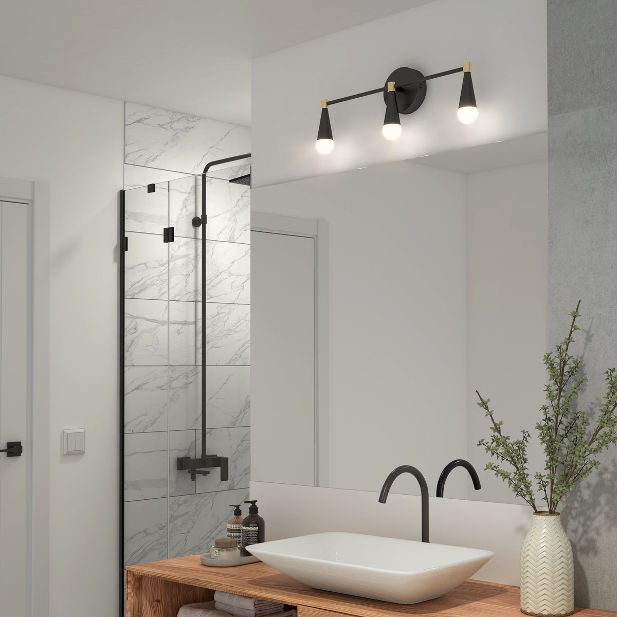Modern bathroom with a wooden vanity, rectangular vessel sink, black faucet, and a large mirror. A black and gold three-light fixture is above the mirror. There’s a glass shower with marble tile and a plant on the counter.
