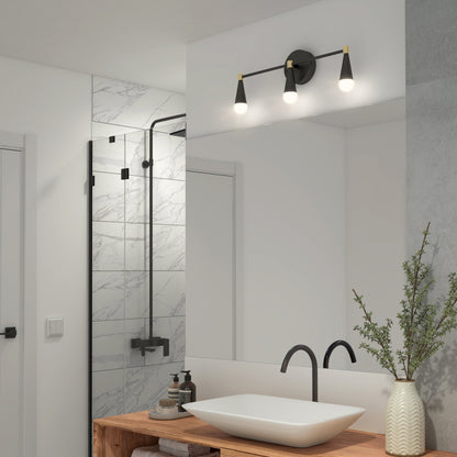 Modern bathroom with a wooden countertop, rectangular vessel sink, black faucet, potted plant, soap dispensers, and large mirror. Above the mirror is an Artika Wayden LED mid-century bathroom vanity light 3 CCT. Marble-tiled shower behind.