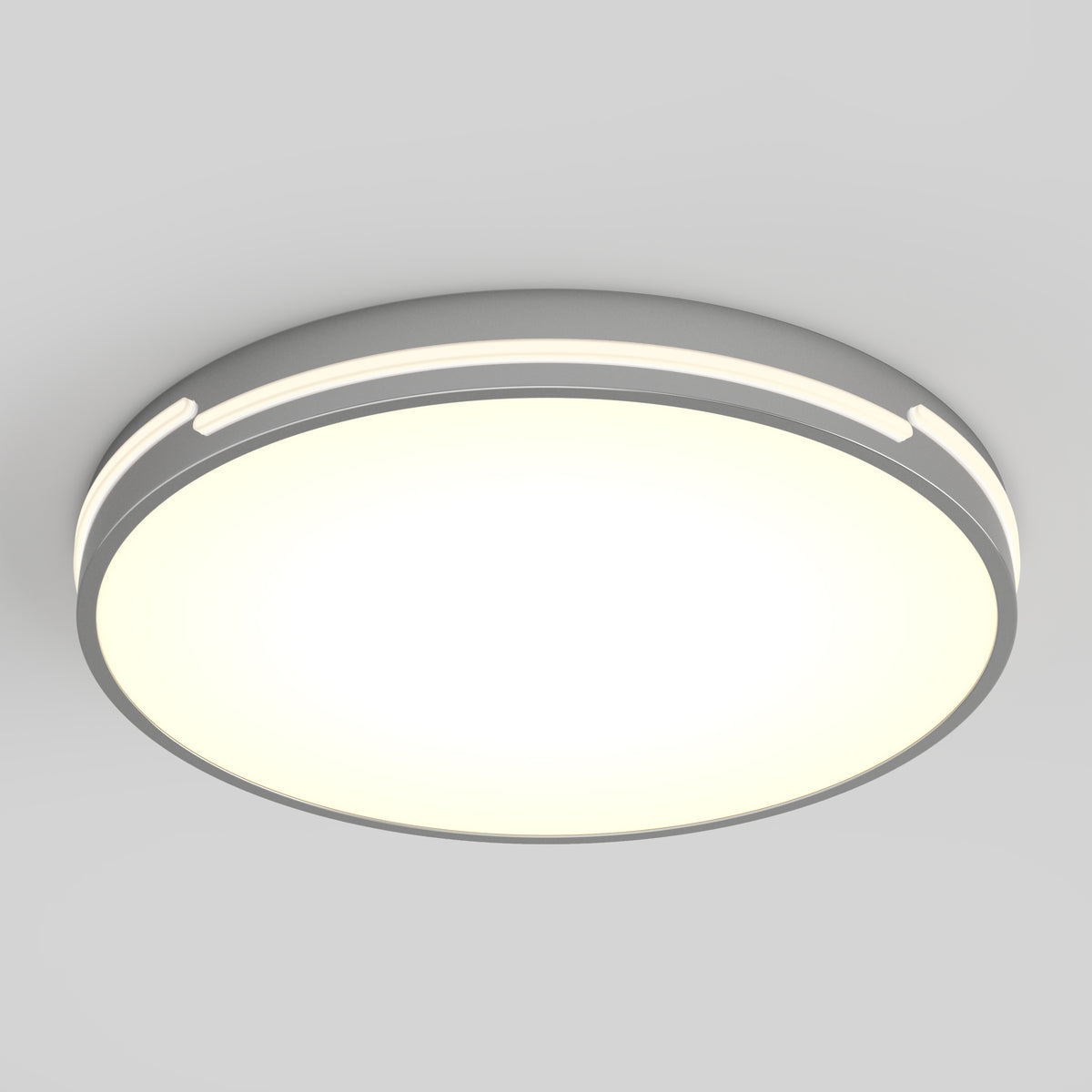 A round, modern ceiling light fixture with a glowing white center and a sleek gray rim, mounted on a plain light gray ceiling.