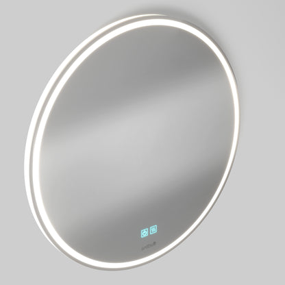 The Artika Emeraude anti fog LED wall mirror is round, wall-mounted, and features a glowing white LED edge with two blue touch icons on the glass, displayed against a plain gray background.