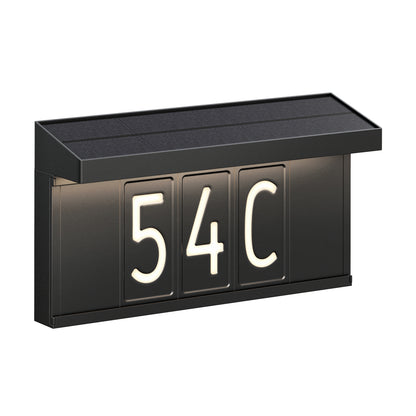 The Artika Bowen solar LED outdoor address wall light 5 CCT is a black rectangular fixture with three illuminated panels displaying ‘54C’ in white beneath a slanted top, offering maintenance-free outdoor house number visibility.