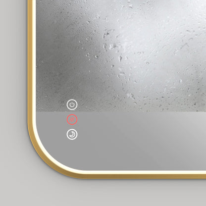 Close-up of the Artika Royce Dimmable LED Mirror (3 CCT), mounted horizontally, with a golden frame and touch controls—featuring an illuminated red defogger icon. Enjoy adjustable color temperature for personalized lighting.