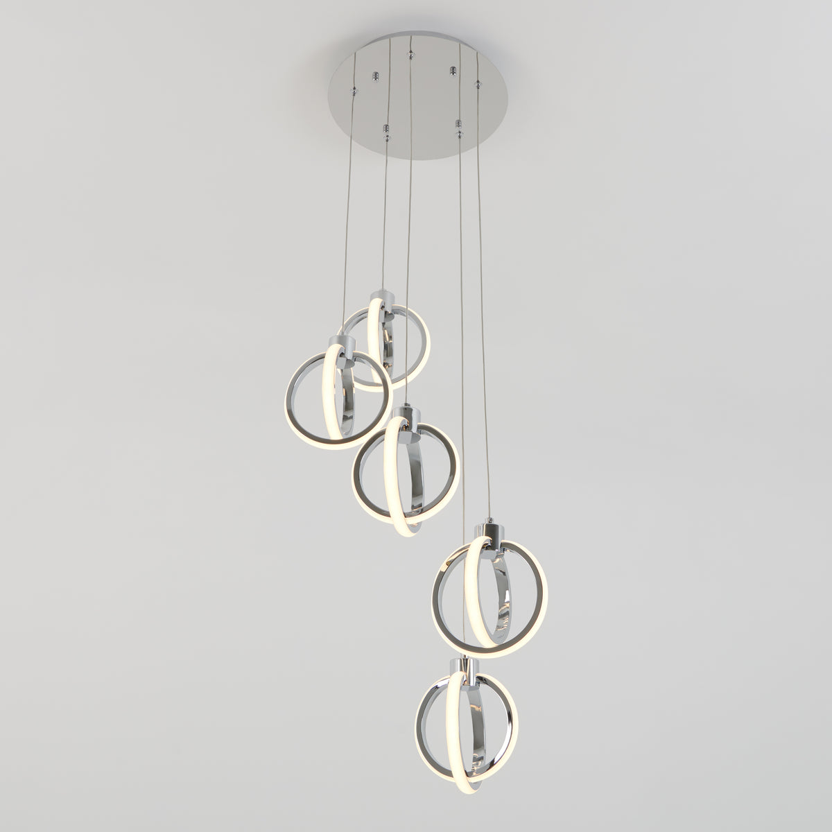 Modern ceiling light fixture with five circular LED rings hanging at different lengths from a round metallic base, against a plain white background.