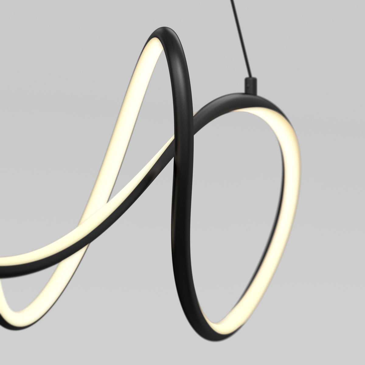 A modern, black pendant light with a continuous, looping LED strip design hanging against a plain, light gray background.