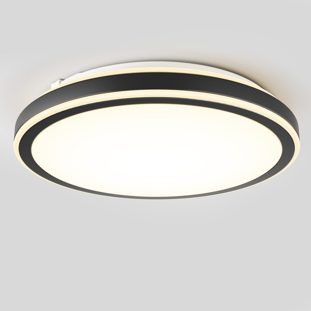 A modern circular ceiling light with a black outer ring and a glowing white center, mounted on a plain grey ceiling.