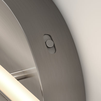 Close-up of the Artika Cisco modern LED bathroom vanity light 5 CCT, showing its brushed metal surface with an embedded small oval switch and part of the fixture visible on the left.
